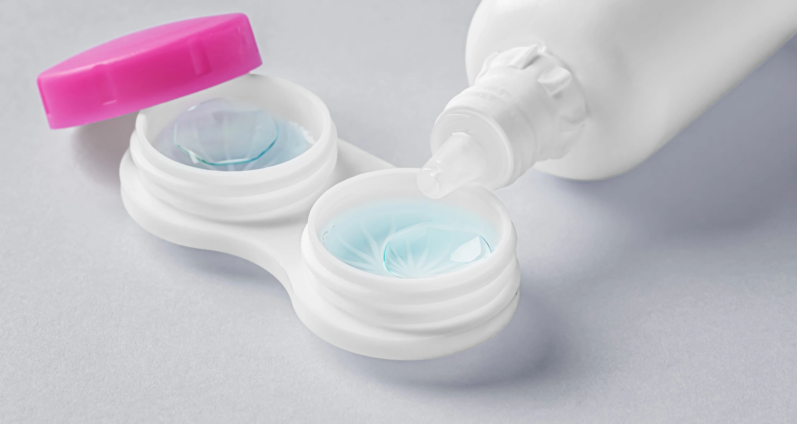 Contact lens case with solution bottle