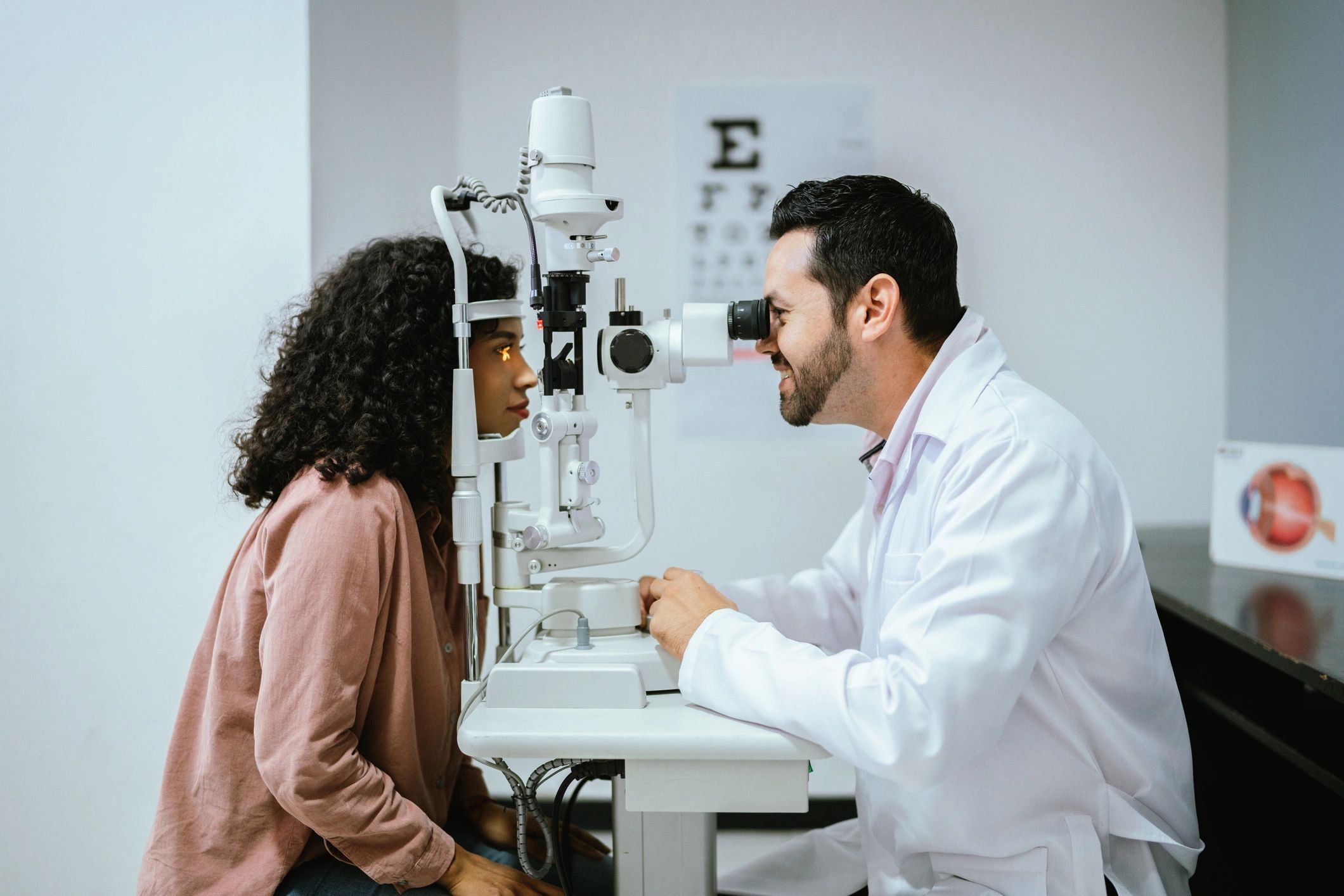 Optician helping a customer during an eye exam